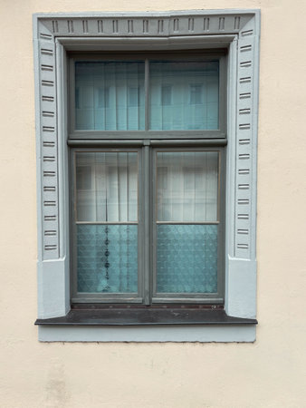 Vintage, grunge window isolated on beige wall background, old window. Old architecture of Europe.