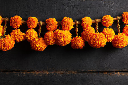 Marigold flowers on black painted board. Day of the Dead or Halloween background. Copy spaceの素材