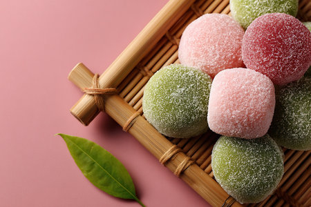 Japanese mochi cake in rice dough. A traditional Japanese dessert on a pink background. Copy space.の素材