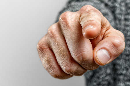 A close-up of a man's hand menacingly pointing his index finger directly at the camera. The finger is pointing at you.の素材