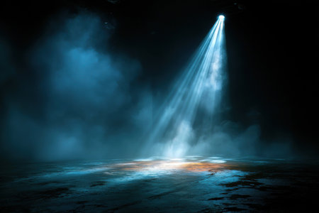 Spotlights pierce the stage smoke on the empty, dark stage. The concept of the stage and performanceの素材