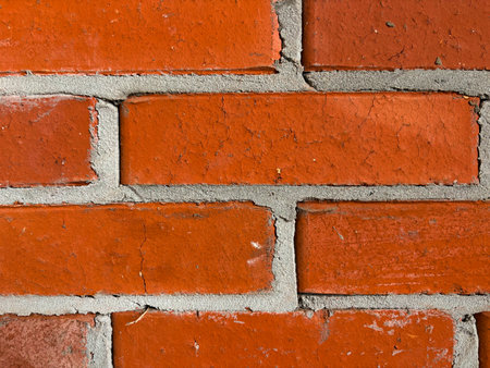 A close-up of a new brick wall. Cement between the bricks. Red brick texture background.の写真素材