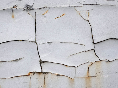 Cracked texture of white paint on rusty metal with mold. Texture of old paint.の写真素材