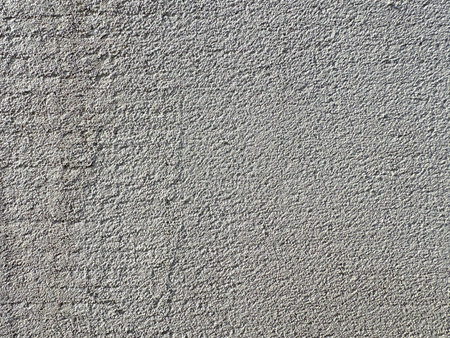 Monolithic wall background. Horizontal light gray grunge texture with copy space. Gray concrete texture.の写真素材