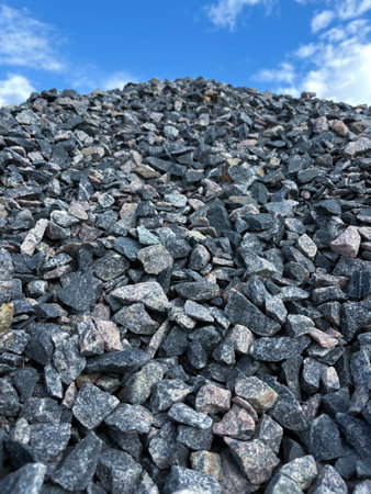 A close-up view of a pile of construction rubble against a blue sky. Construction materials delivery. Bulk cargoの写真素材