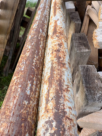 metal pipes are covered with brown corrosion and rust. Construction waste.の写真素材