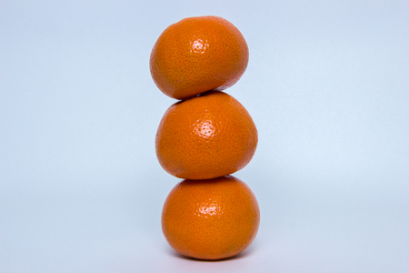 Some ripe and juicy orange mandarin on a gray backgroundの写真素材