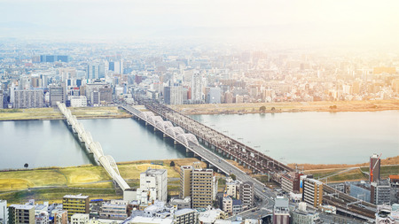 Business concept for real estate and corporate construction - panoramic modern city skyline bird eye aerial view with dramatic sunrise and morning sky in Osaka, Japanのeditorial素材