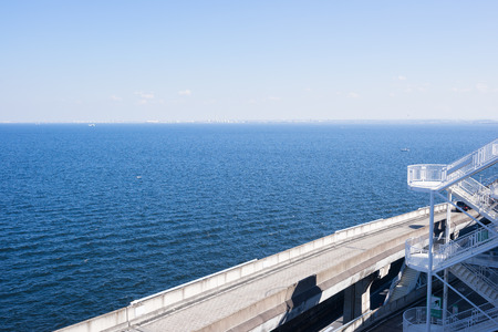 panoramic bird eye top aerial view with beautiful sea level with highway road under dramatic clear glow and fantasy blue sky in Umi Hotaru parking area island Tokyo bay aqua line, Japanのeditorial素材
