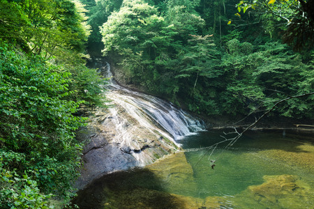Japan travel concept - beautiful yoro keikoku valley waterfall under dramatic sun glow and morning blue sky in Chiba Prefecture, Japanのeditorial素材