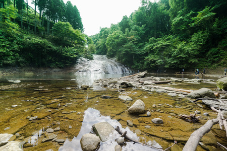 Japan travel concept - beautiful yoro keikoku valley waterfall under dramatic sun glow and morning blue sky in Chiba Prefecture, Japanのeditorial素材