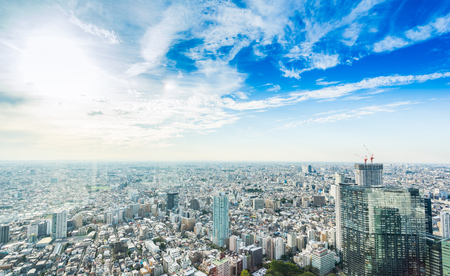 Business and culture concept - panoramic modern city skyline bird eye aerial view under dramatic sun and morning blue cloudy sky in Tokyo, Japanのeditorial素材