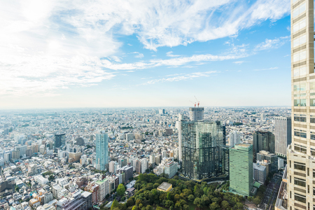 Business and culture concept - panoramic modern city skyline bird eye aerial view with Tokyo Metropolitan Government Building under dramatic sun and morning blue cloudy sky in Tokyo, Japanのeditorial素材