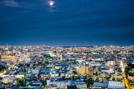 Business and culture concept for real estate and corporate construction - panoramic modern city skyline bird eye aerial night view under dramatic neon glow and beautiful dark blue sky in Tokyo, Japanのeditorial素材