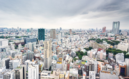Business and culture concept - panoramic modern city skyline bird eye aerial view from tokyo tower under dramatic grey cloudy sky in Tokyo, Japanのeditorial素材