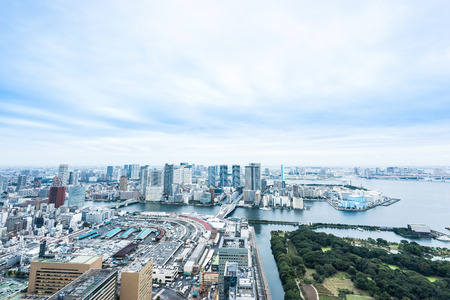 Business and culture concept - panoramic modern city skyline bird eye aerial view of Odaiba bay and bridge under dramatic morning blue cloudy sky in Tokyo, Japanのeditorial素材