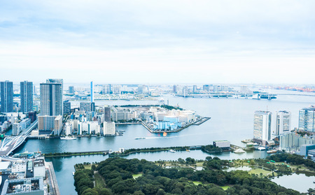 Business and culture concept - panoramic modern city skyline bird eye aerial view of Odaiba bay and rainbow bridge under dramatic morning blue cloudy sky in Tokyo, Japanのeditorial素材