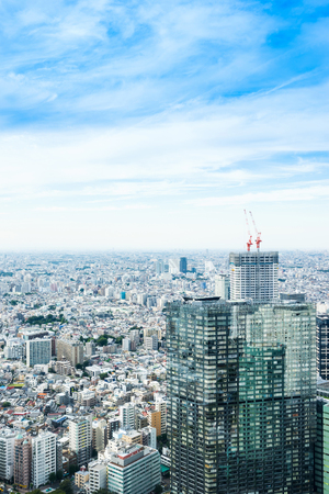 Business and culture concept - panoramic modern city skyline bird eye aerial view under dramatic sun and morning blue cloudy sky in Tokyo, Japanのeditorial素材