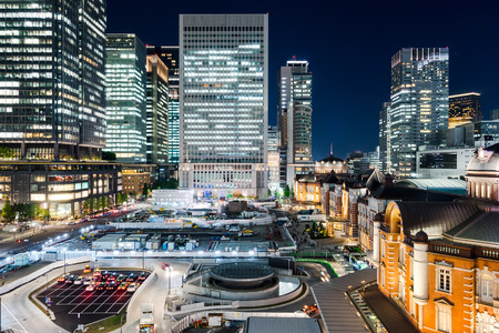 Asia Business concept for real estate and corporate construction - panoramic modern cityscape building bird eye aerial night view of Tokyo Station under neon light and dark blue sky in Tokyo, Japanのeditorial素材