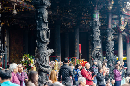 Taipei, Taiwan - Dec. 3, 2016 : Asia culture concept - people pray for god in famous heritage landmark, the traditional old oriental Chinese temple, lungshan with with beautiful dragon pillar decorationのeditorial素材
