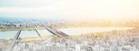 Asia Business concept for real estate and corporate construction - panoramic modern cityscape building bird eye aerial view under sunrise and morning blue bright sky in Osaka, Japan. Mix hand drawn sketch illustrationの写真素材