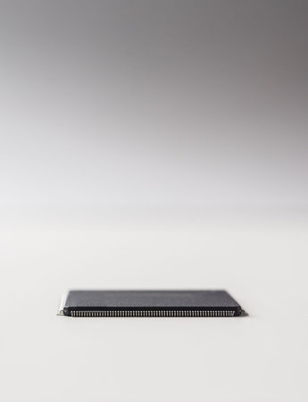 Business concept - semiconductor IC chip isolated on grey background.