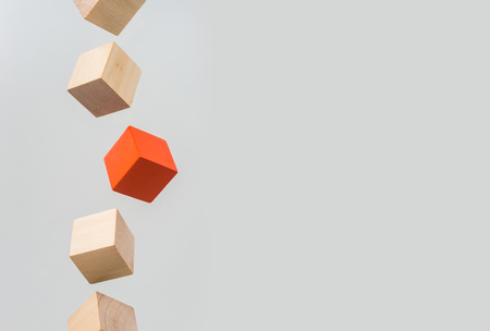 Business concept - Abstract geometric real floating wooden cube on grey background and it's not 3D render. the symbol of leadership, teamwork and growth.の写真素材