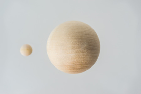 Surreal design concept - real wooden ball float on grey background like the planet on the universeの写真素材