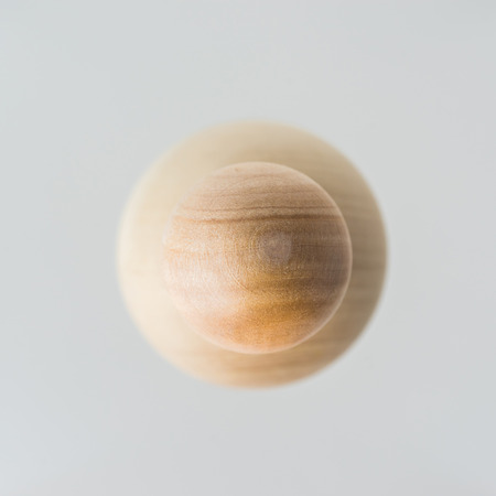 Surreal design concept - real wooden ball float on grey background like the planet on the universeの写真素材
