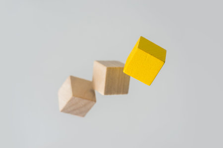 Business concept - Abstract geometric real floating wooden cube on grey background and it's not 3D...