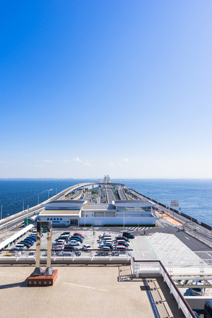 panoramic bird eye top aerial view with beautiful sea level with highway road under dramatic clear glow and fantasy blue sky in Umi Hotaru parking area island Tokyo bay aqua line, Japanのeditorial素材