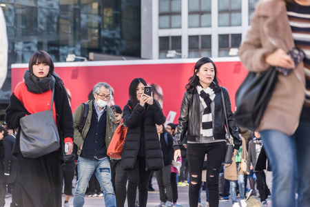 Tokyo, Japan - Dec 3, 2017: woman take picture with phone on Shibuya crossingのeditorial素材