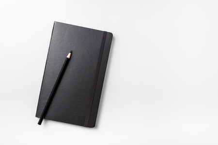 Business concept - Top view collection of black hardcover notebook and black pencil isolated on background for mockupの写真素材