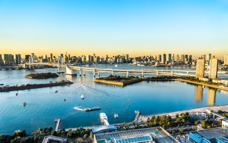 Asia Business concept for real estate and corporate construction - panoramic modern city skyline bird eye aerial view of Odaiba, tokyo tower & rainbow bridge under golden sun in Tokyo, Japanの写真素材
