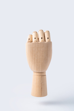 Business and design concept - wooden raise hand with fist posture isolated on white backgroundの写真素材