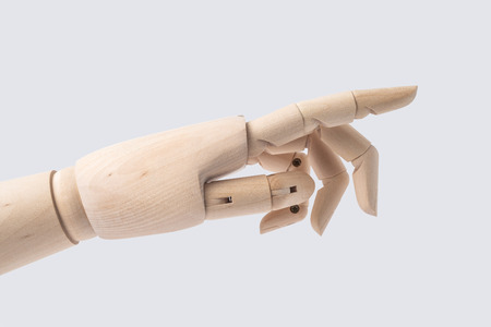 Business and design concept - wooden hand with start posture isolated on white backgroundの写真素材
