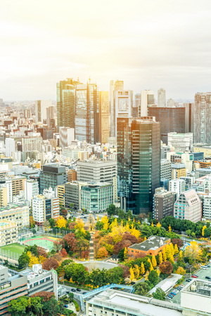 Asia Business concept for real estate and corporate construction - urban city skyline aerial view of shiodome under bright blue sky and sun in Tokyo, Japanのeditorial素材
