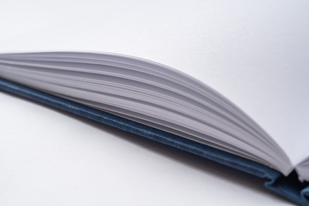 Design concept - Perspective view blue hardcover notebook with open  and flip curl rolled page isolated on background for mockup.の写真素材