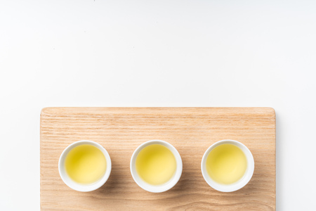 Asia culture and design concept - fresh taiwan oolong tea and cup with wood boardの写真素材