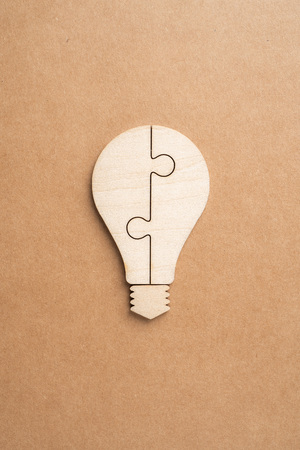 Business and design concept - light bulb jigsaw icon on kraft paper. it's conversation, leadership conceptの写真素材