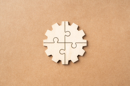 Business and design concept - gear jigsaw icon on kraft paper for infographic mockupの写真素材