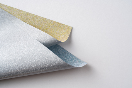 Design concept - silver and golden folded paper on golden backgroundの写真素材