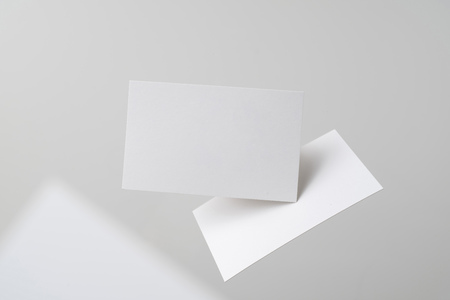 Design concept - front view of 2 surreal white business card float on mid air isolated on white backgroundの写真素材