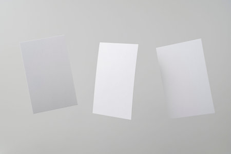 Design concept - front view of 3 surreal white business card float on mid air isolated on white...