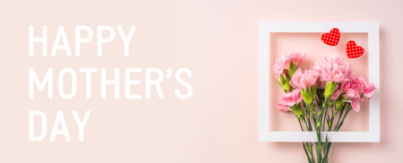 event design concept - top view of a bunch of pink carnation with white photo frame and greeting...
