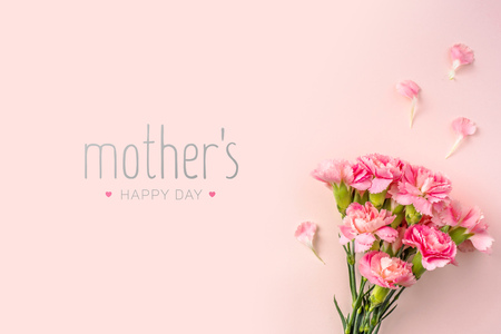 event design concept - top view of a bunch of pink carnation with greeting word on pink background for mothers day event with copy space for mock upの写真素材