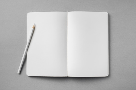 Top view of open white notebook with blank page and wooden pencil on grey backgroundの写真素材