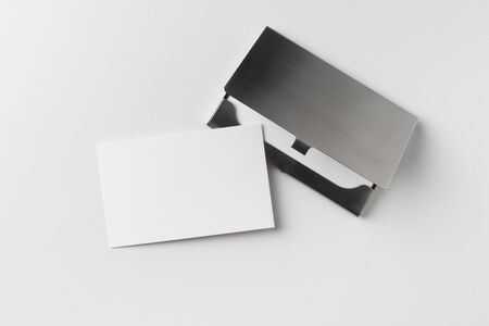 Design concept - top view of horizontal business card with stainless steel case isolated on white backgroundの写真素材