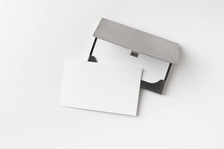 Design concept - top view of horizontal business card with stainless steel case isolated on white backgroundの写真素材
