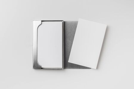 Design concept - top view of vertical business card with stainless steel case isolated on white backgroundの写真素材